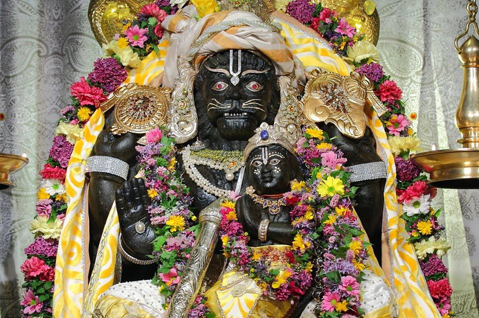Narasimha showing fatherly love to child devotee Prahlad